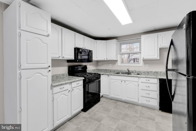 kitchen featuring black appliances and white cabinets