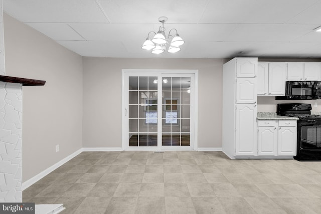 kitchen featuring a notable chandelier, black appliances, white cabinets, light stone countertops, and decorative light fixtures