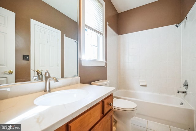 full bathroom with vanity, tiled shower / bath, tile patterned flooring, and toilet