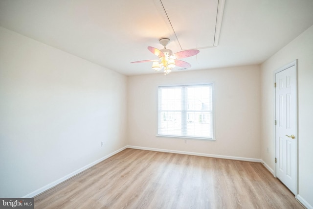 empty room with ceiling fan and light hardwood / wood-style floors