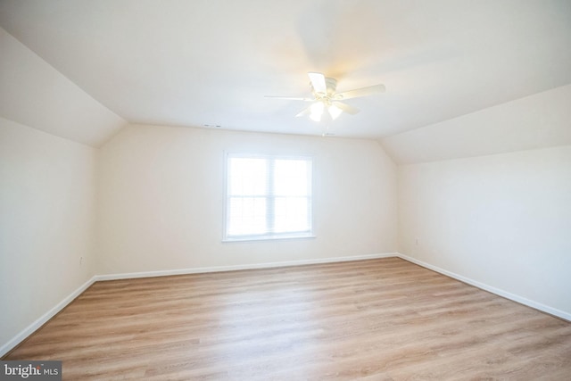 additional living space featuring ceiling fan, vaulted ceiling, and light hardwood / wood-style flooring