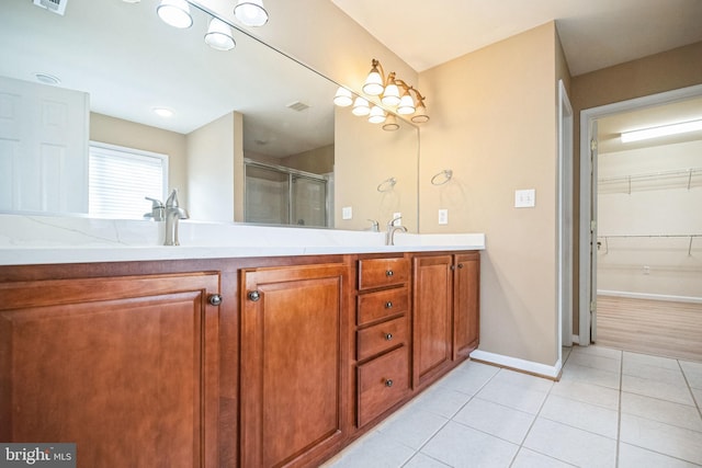 bathroom with vanity, an enclosed shower, and tile patterned flooring