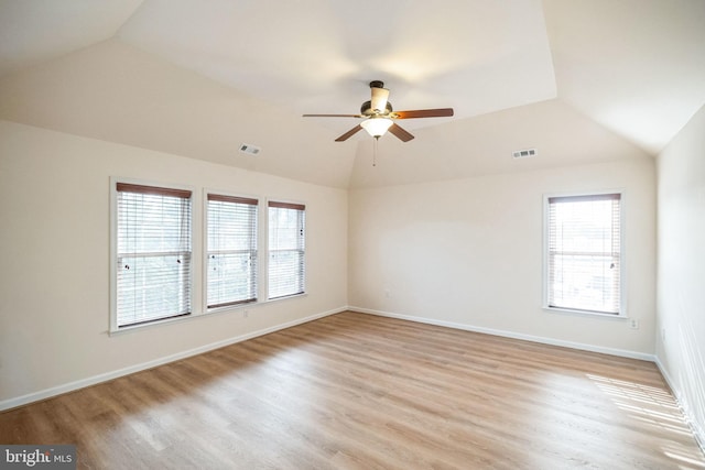 spare room with ceiling fan, lofted ceiling, and light wood-type flooring