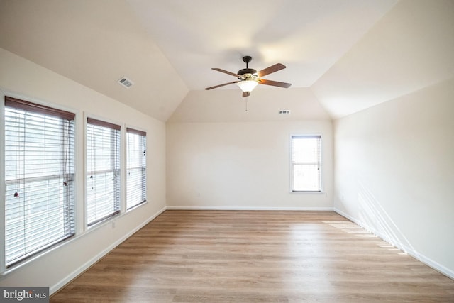 spare room with ceiling fan, lofted ceiling, and light wood-type flooring