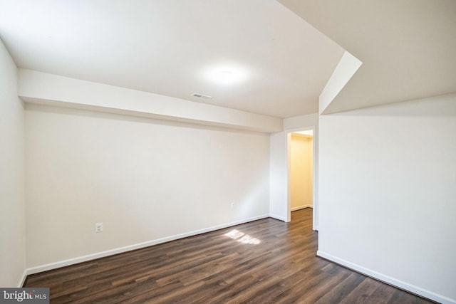 basement with dark hardwood / wood-style floors