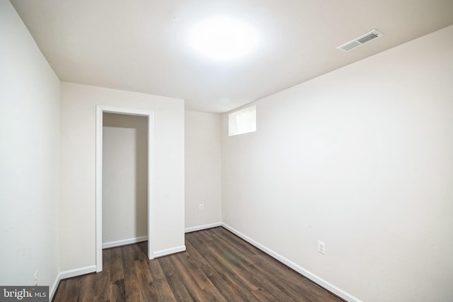 unfurnished room featuring dark wood-type flooring