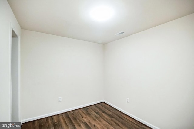 spare room featuring dark hardwood / wood-style flooring