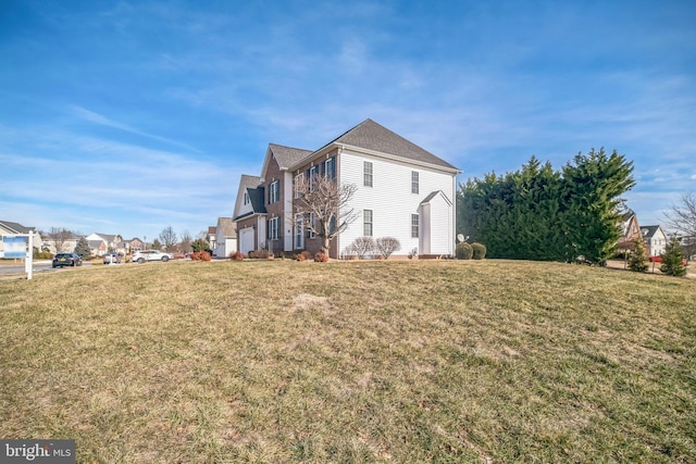 view of side of property with a garage and a yard