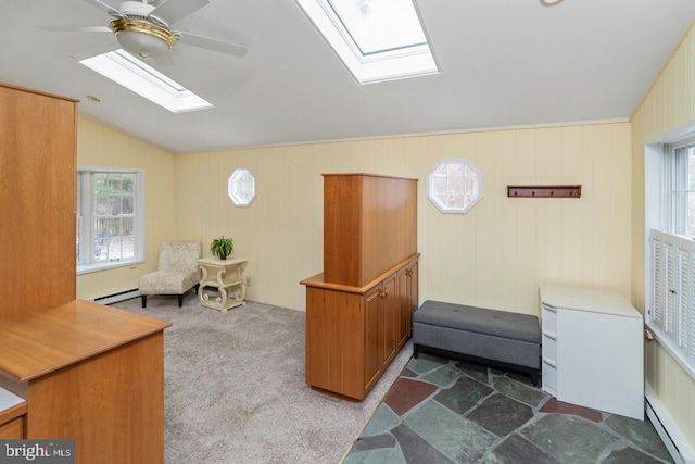 living area with ceiling fan, lofted ceiling, baseboard heating, and dark colored carpet