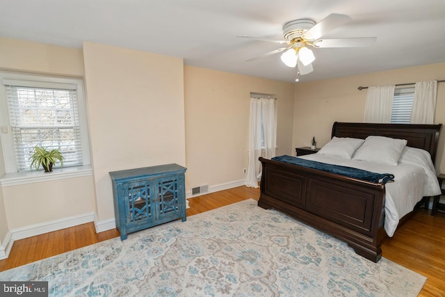 bedroom with ceiling fan and light hardwood / wood-style floors