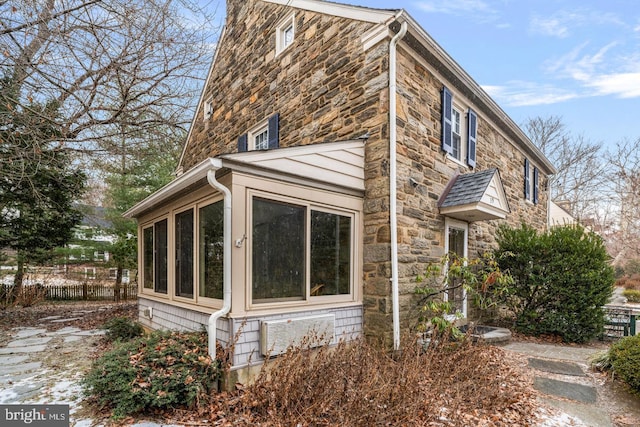 view of side of home with a sunroom