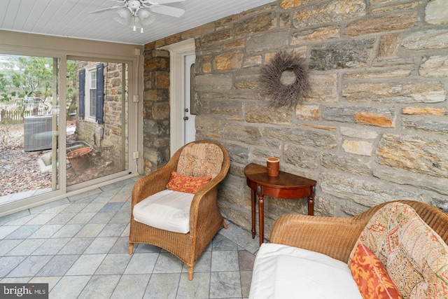 sitting room with ceiling fan and wood ceiling