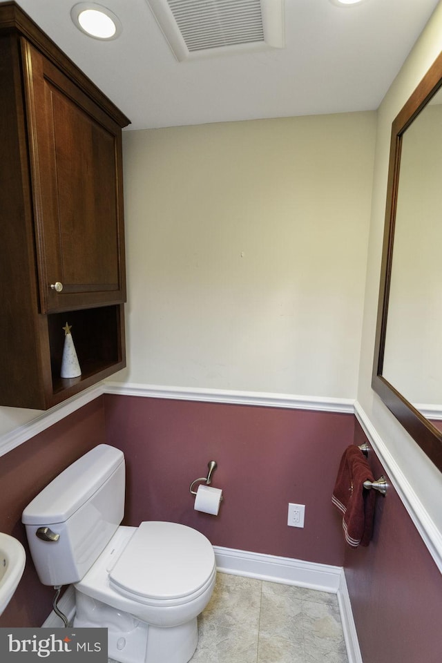 bathroom featuring toilet and tile patterned flooring