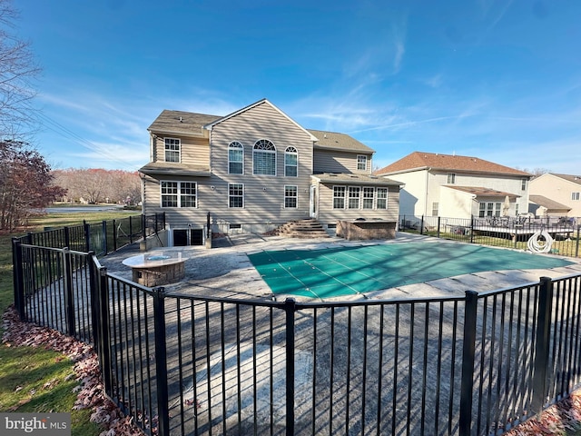 view of swimming pool featuring a fire pit, a fenced backyard, a fenced in pool, and entry steps