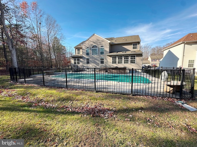 view of swimming pool featuring a patio, fence, a fenced in pool, and a yard