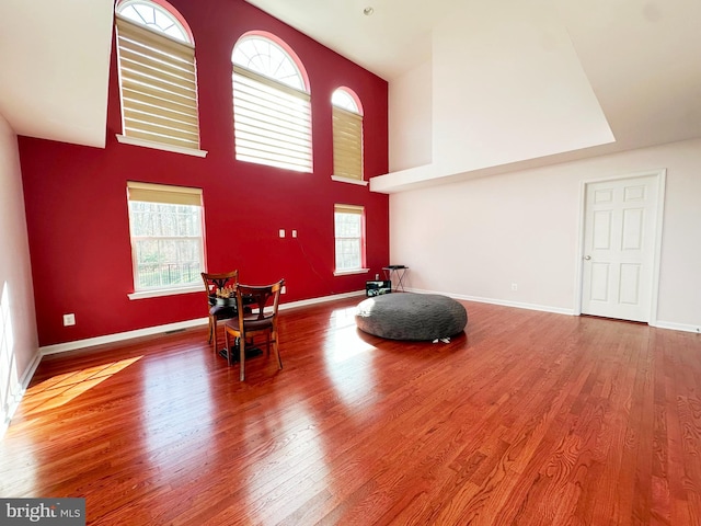 sitting room featuring plenty of natural light, baseboards, and wood finished floors