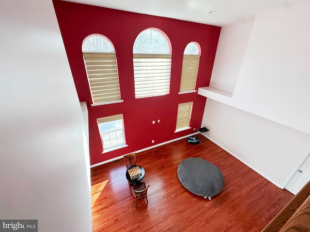 interior space with wood finished floors, visible vents, and baseboards