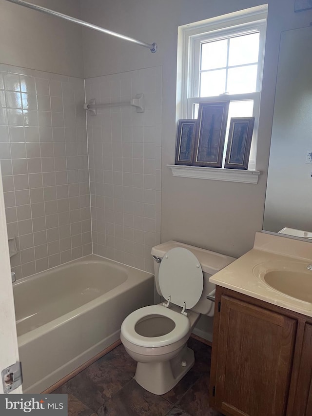 full bathroom with vanity, toilet, and tiled shower / bath