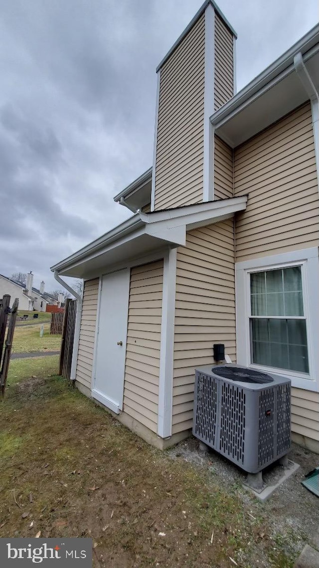 exterior space featuring a lawn and central air condition unit