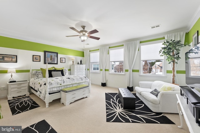 bedroom with ceiling fan and crown molding