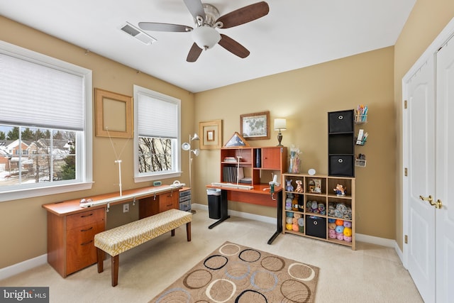 carpeted home office with ceiling fan