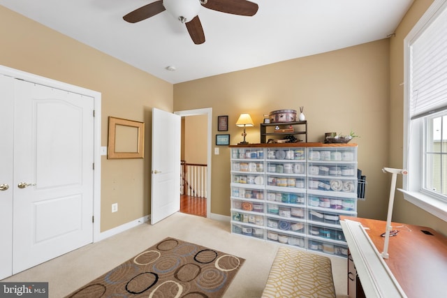 living area featuring ceiling fan and light carpet