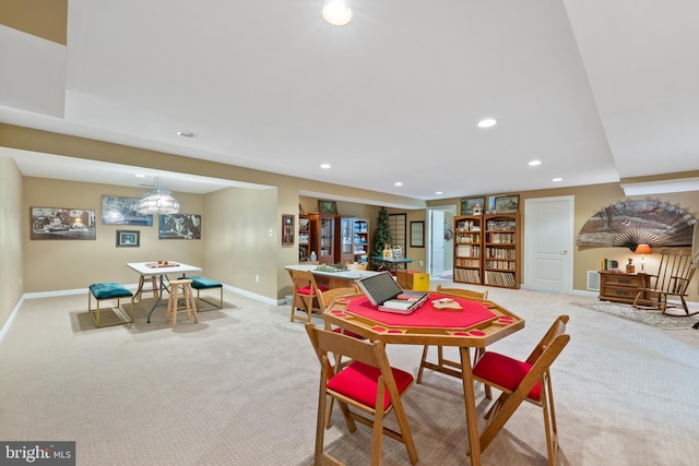 carpeted dining area featuring built in shelves