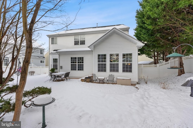 view of snow covered rear of property