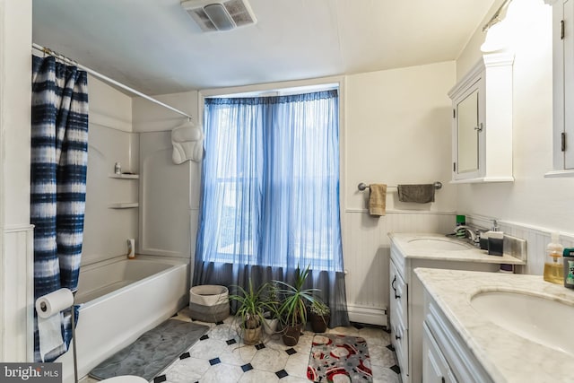 bathroom featuring tile patterned floors, a baseboard heating unit, vanity, and shower / tub combo with curtain