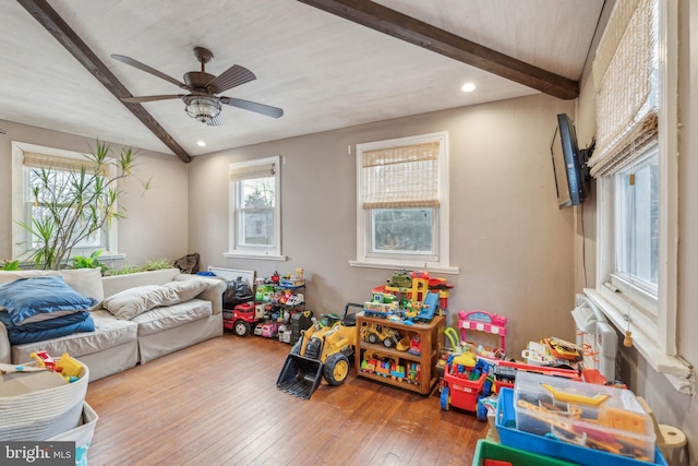 playroom featuring beam ceiling, ceiling fan, and hardwood / wood-style flooring