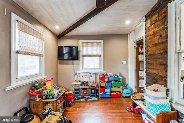 game room with vaulted ceiling with beams, plenty of natural light, and hardwood / wood-style flooring