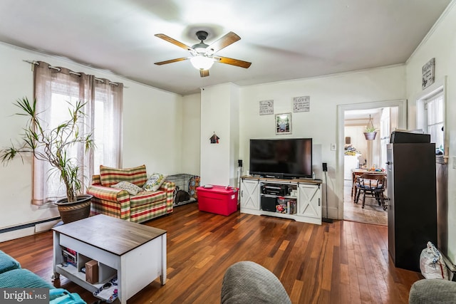 living room with ceiling fan, a baseboard heating unit, and dark wood-type flooring