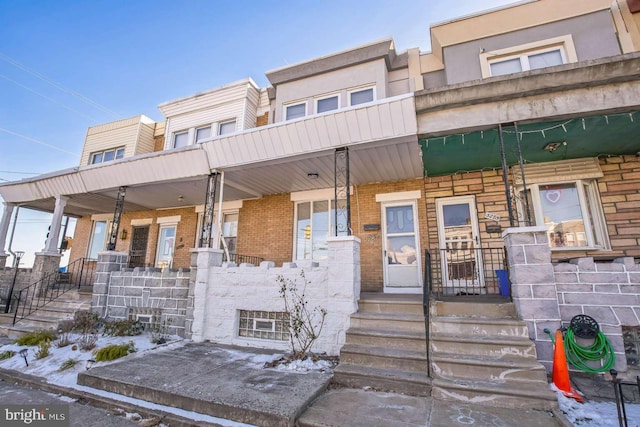 townhome / multi-family property featuring a porch