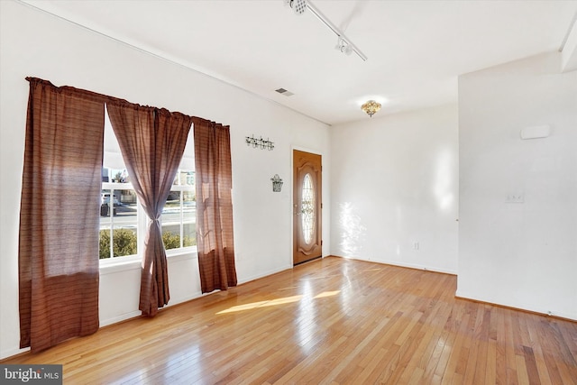 foyer entrance featuring track lighting and light wood-type flooring