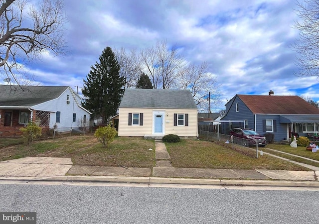 bungalow-style house featuring a front yard