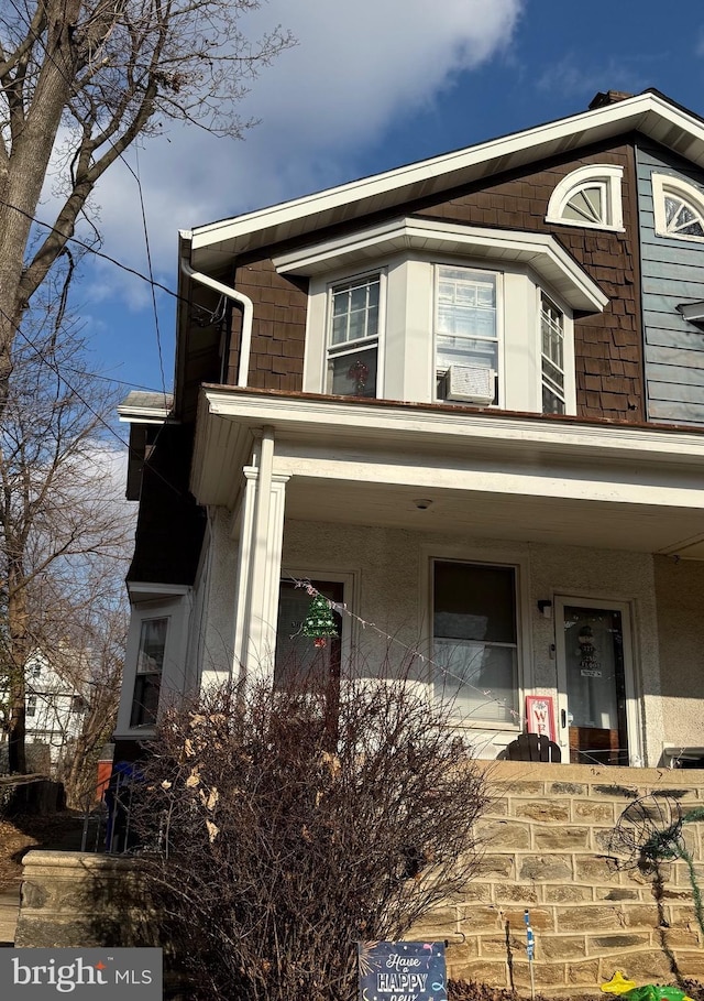 exterior space featuring a porch and stucco siding