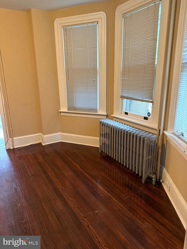 327 Jefferson Ave, Cheltenham, PA 19012 - spare room featuring radiator, dark wood-type flooring, and baseboards