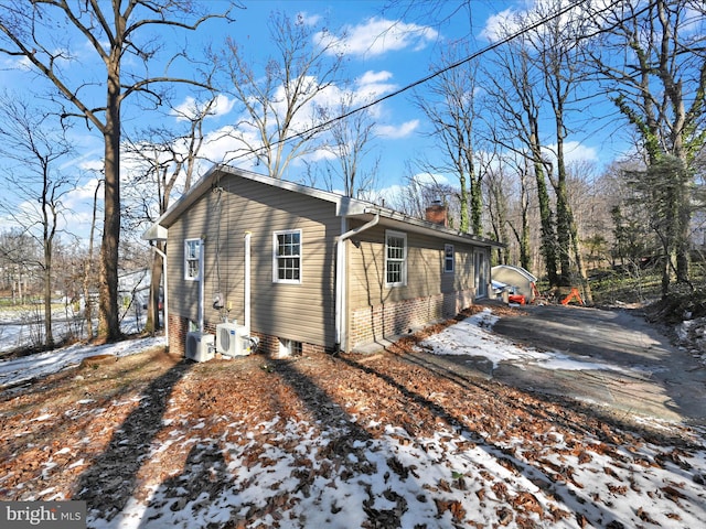 view of snow covered exterior featuring ac unit