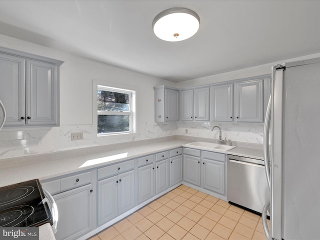 kitchen with sink, dishwasher, refrigerator, gray cabinets, and electric range