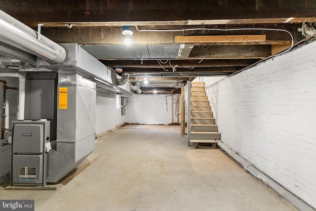 basement with brick wall and heating unit