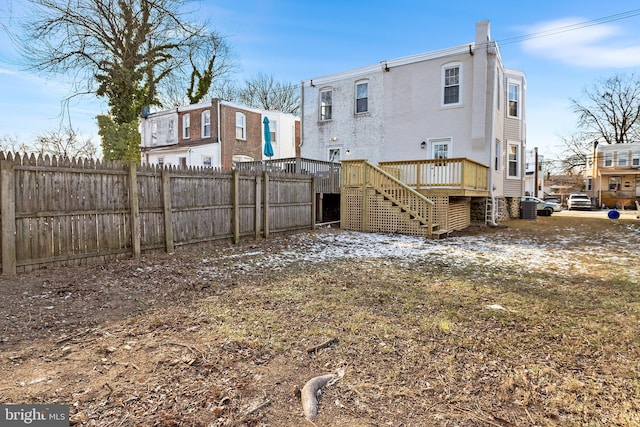 back of house featuring a deck