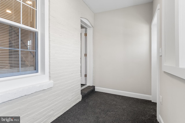 corridor with dark colored carpet