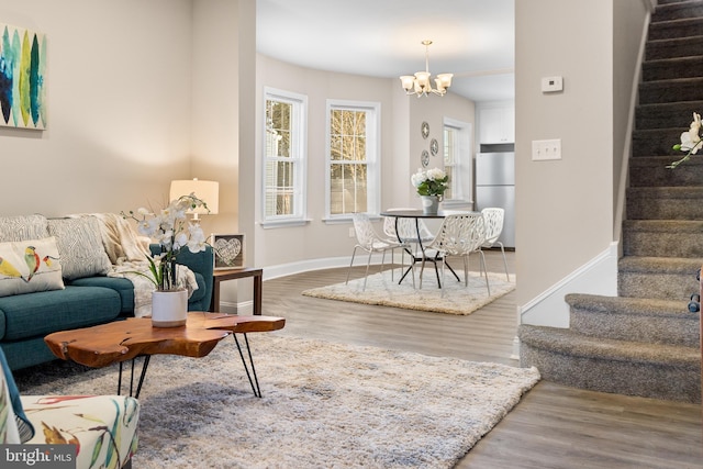 living room featuring a chandelier and wood-type flooring