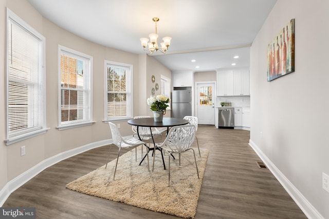 dining room featuring a notable chandelier and dark hardwood / wood-style floors