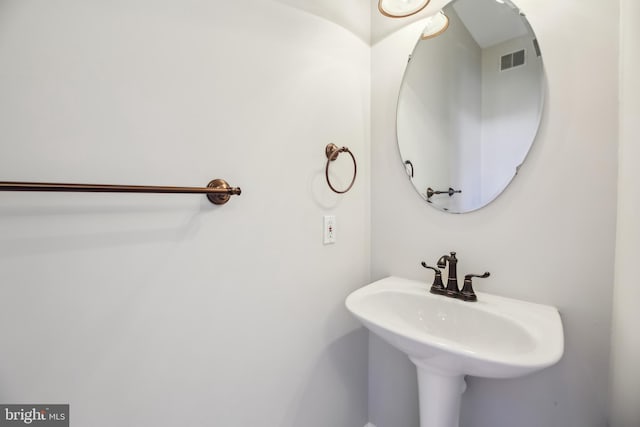 bathroom with visible vents and a sink