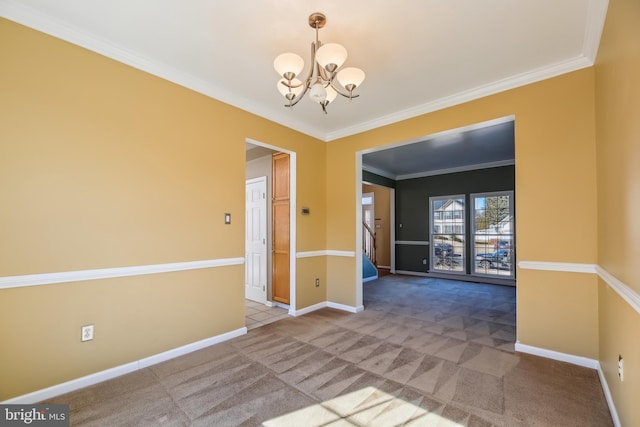 carpeted spare room with stairway, baseboards, a notable chandelier, and ornamental molding