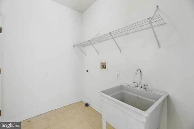 laundry room with laundry area, baseboards, hookup for an electric dryer, washer hookup, and a sink