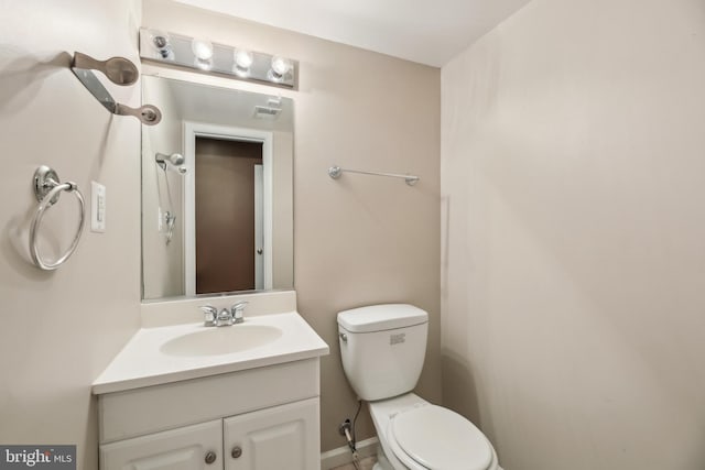 bathroom featuring visible vents, vanity, and toilet