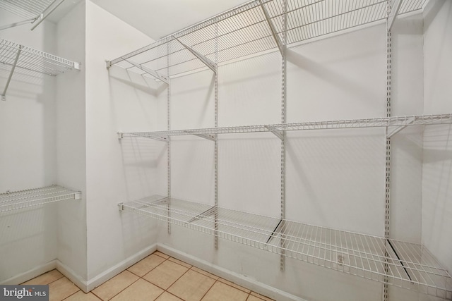 spacious closet featuring tile patterned floors