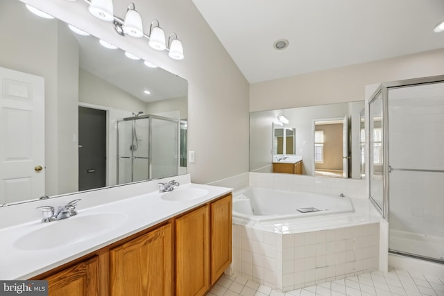 bathroom with double vanity, a sink, a bath, and a shower stall